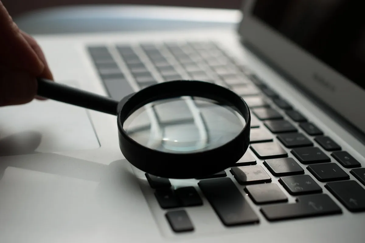 Forensic investigation — magnifying glass and laptop